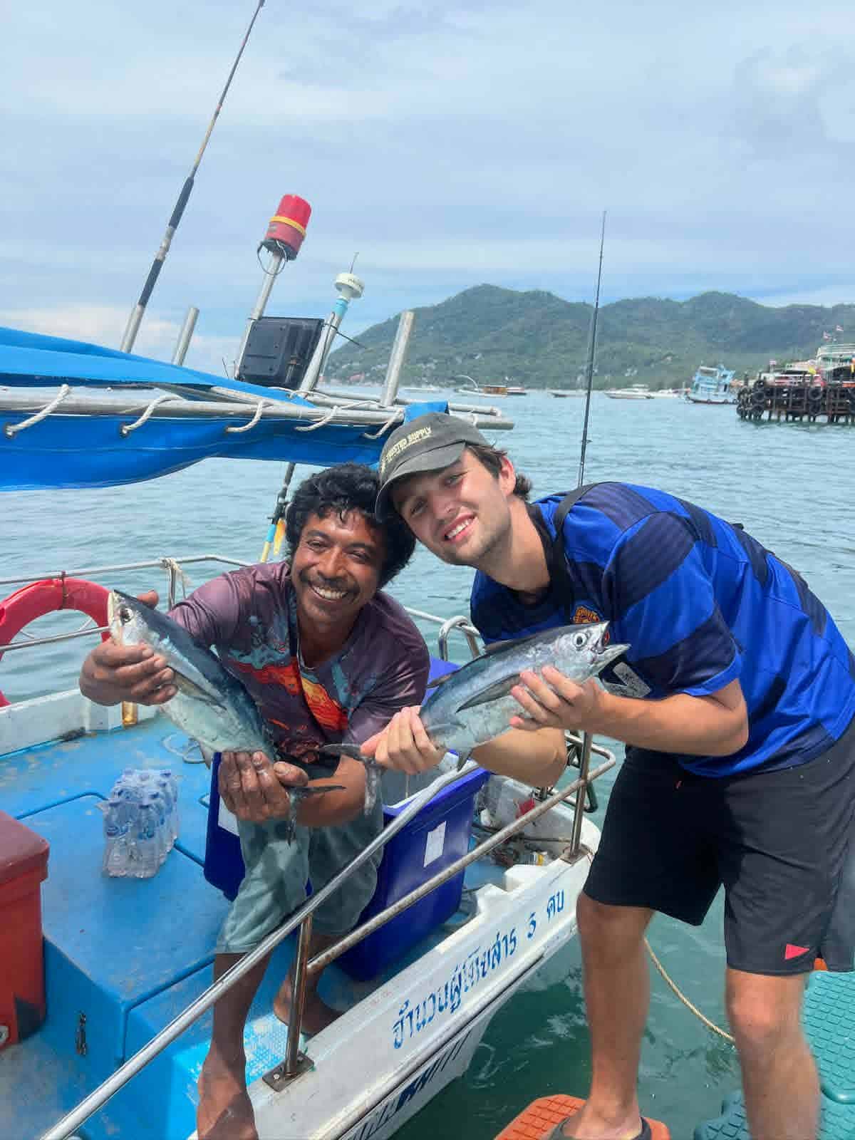Local fishing guide with guests on a boat in Koh Tao