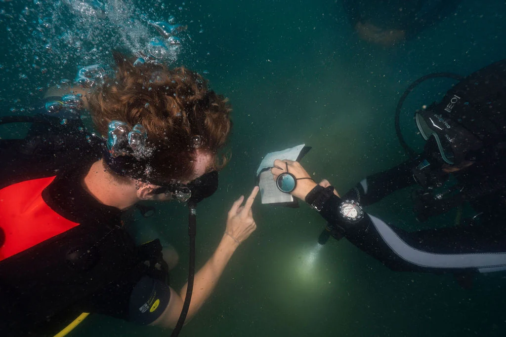 Beginner diver practising underwater skills with an instructor